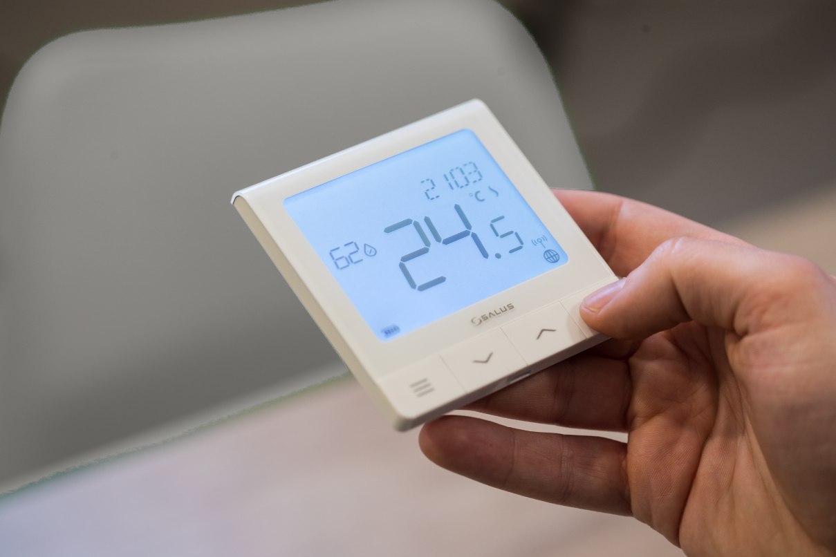 Thermostat RSQ800 tenu dans la main, consigne de 24,5 degrés affichée